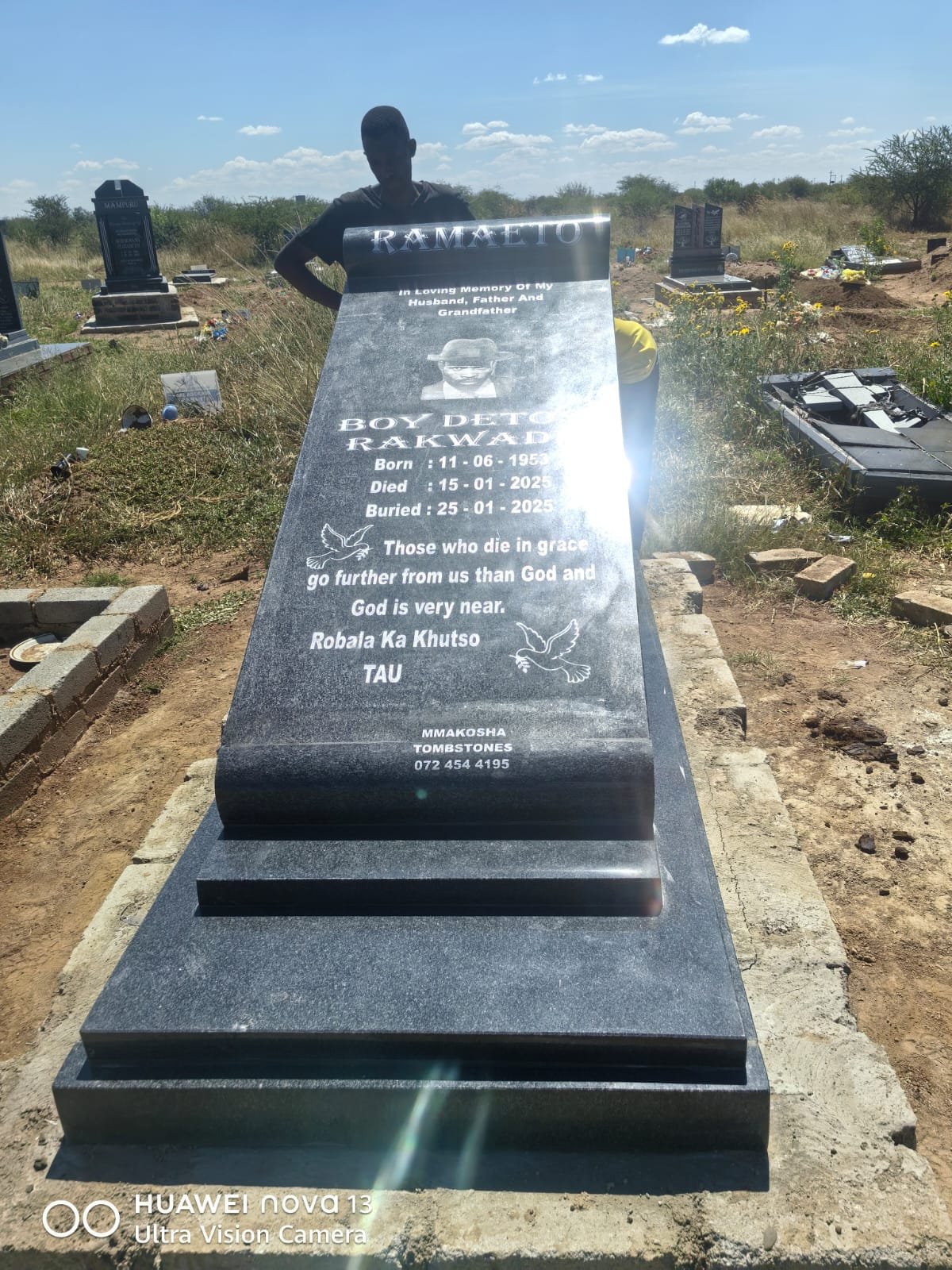 Full-length grey granite memorial with photo portrait