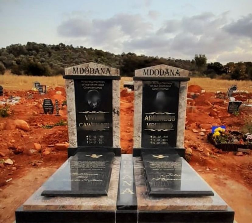 Mdodana double granite tombstone with photo portraits and gold accents