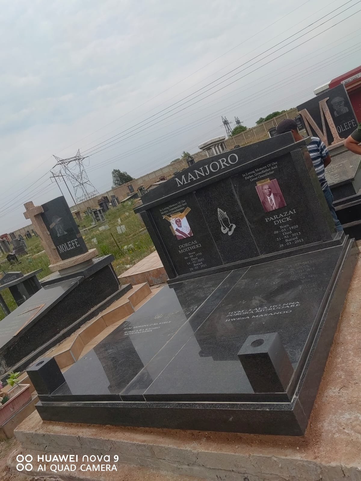 Manjoro double memorial with photo portraits and black granite