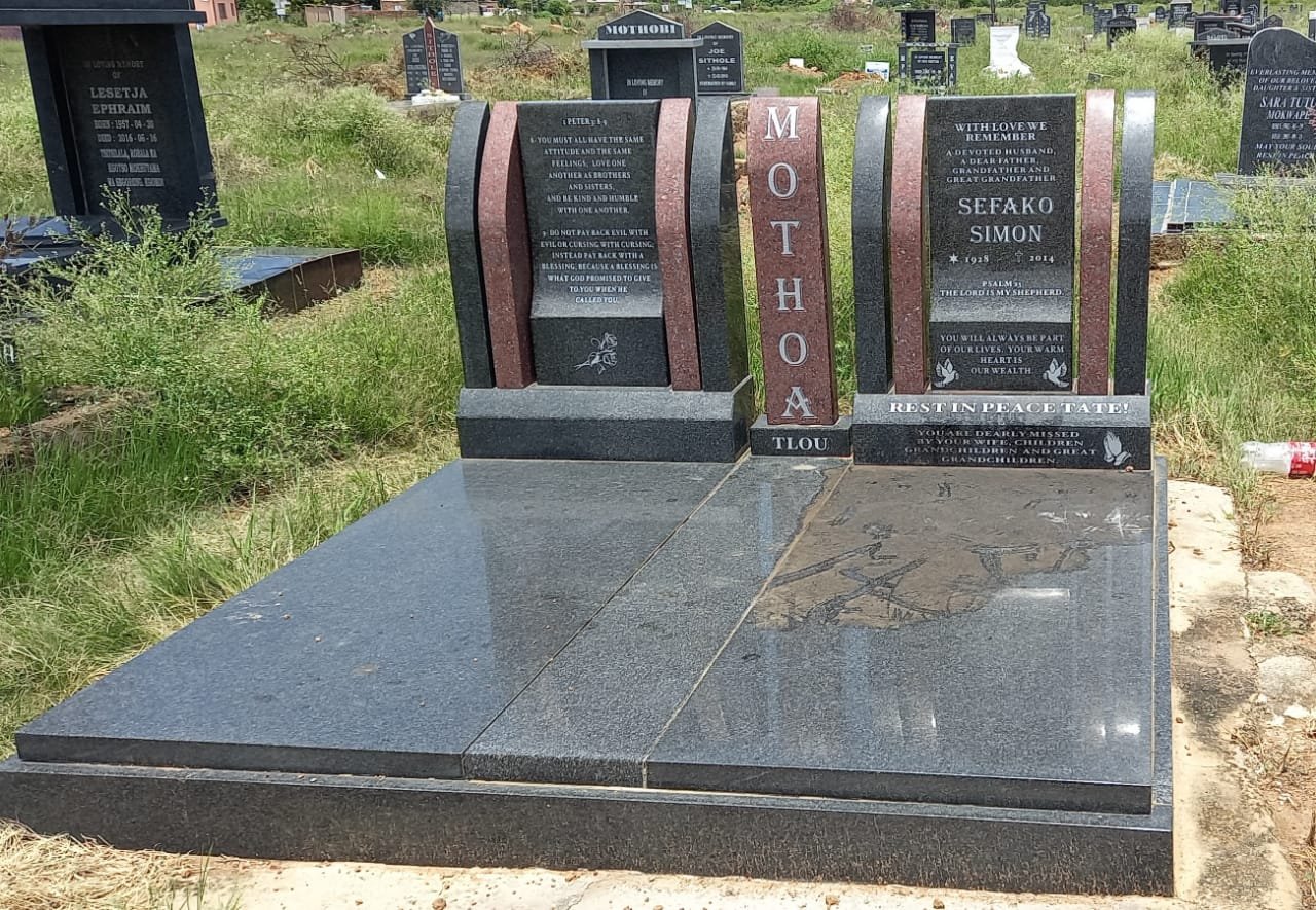 Elaborate single memorial with book pillars and scripture text