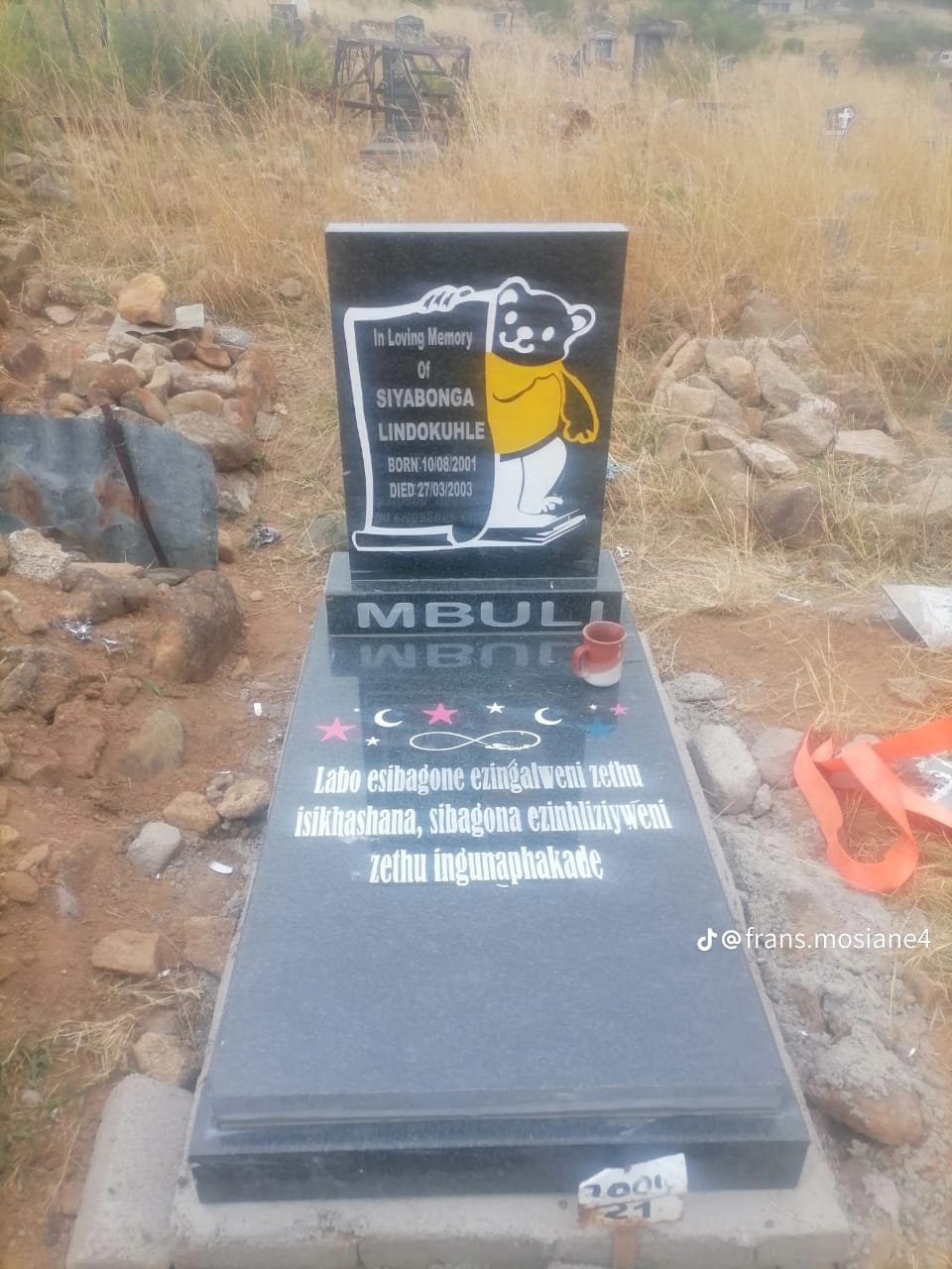 Children's memorial with teddy bear and colorful inscription